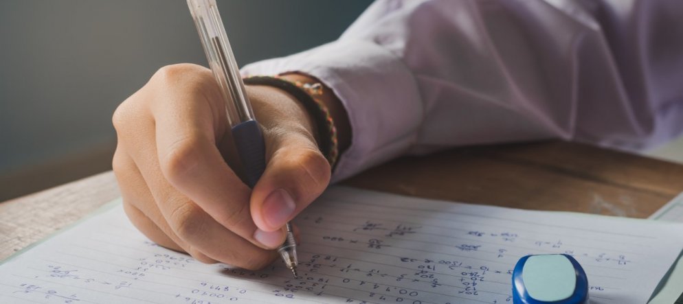 Pen Test Results. A student holding a Pen.